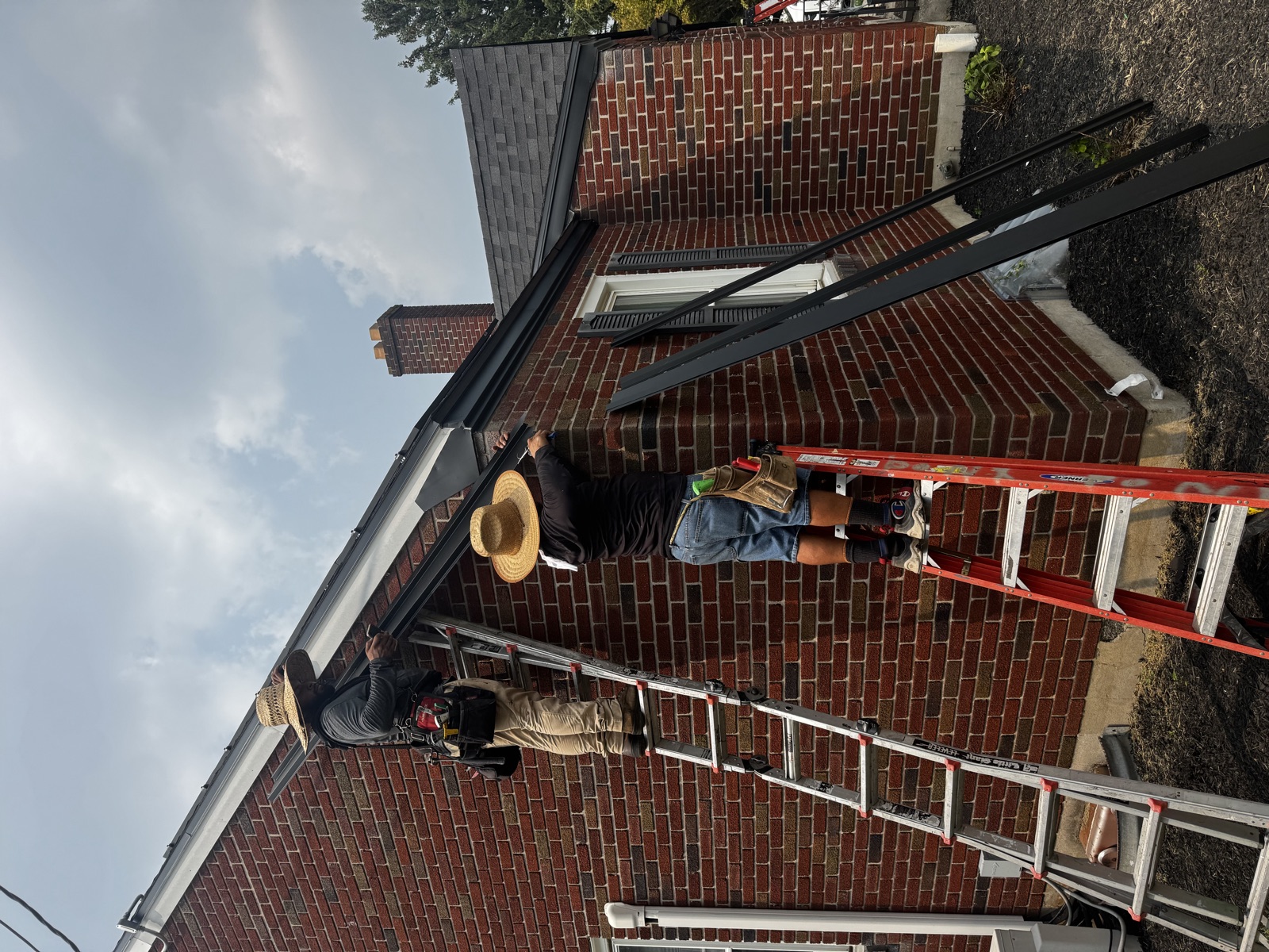 Ridgeway Roofing crew at work on a brick home in Berks County