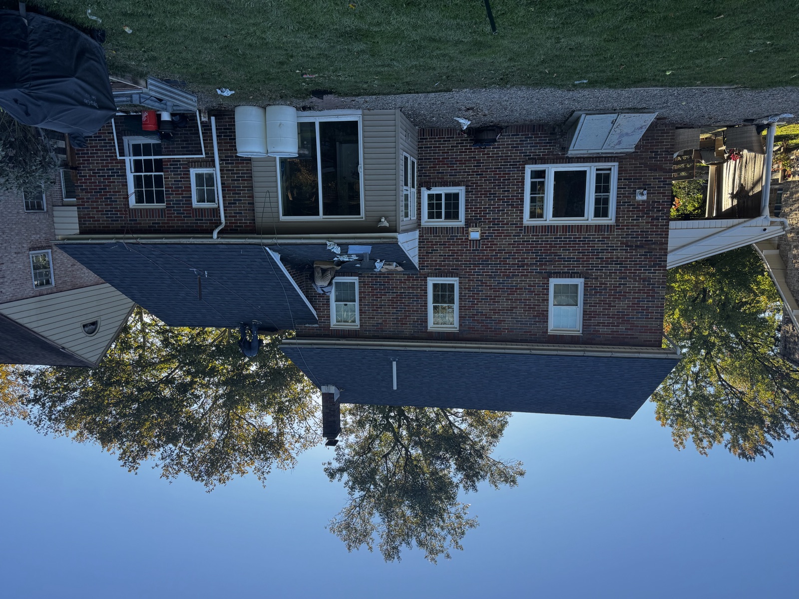 The same home with its completed new architectural shingle roof
